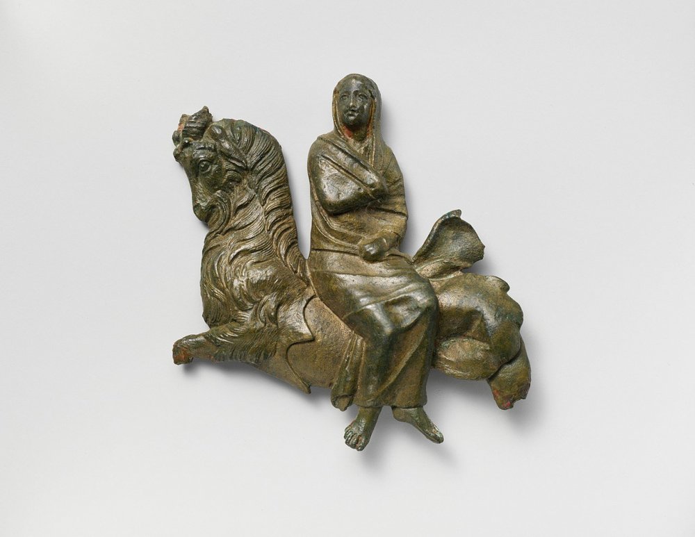 1280px-Bronze_relief_of_a_veiled_woman_riding_a_sea-goat_MET_DP229113.jpg