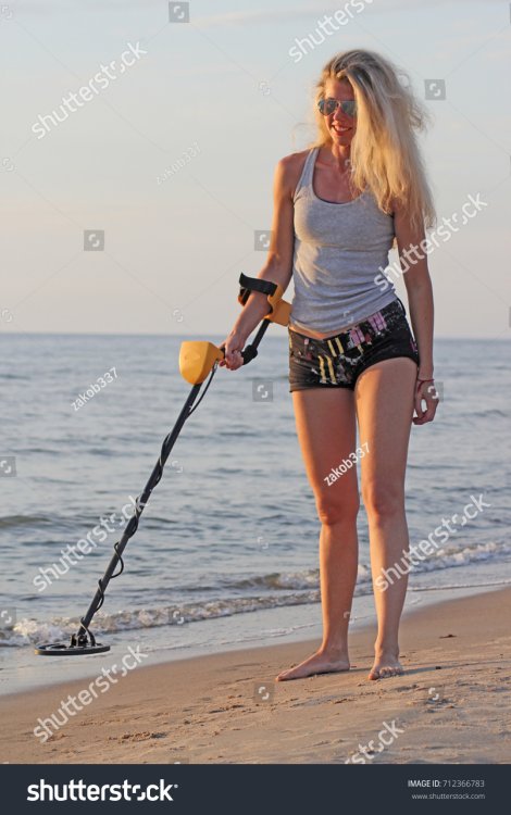 stock-photo-blonde-girl-in-sunglasses-with-metal-detector-on-the-beach-712366783.jpg
